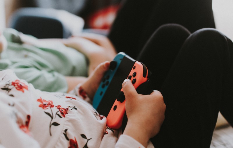 A pair of hands with gaming console