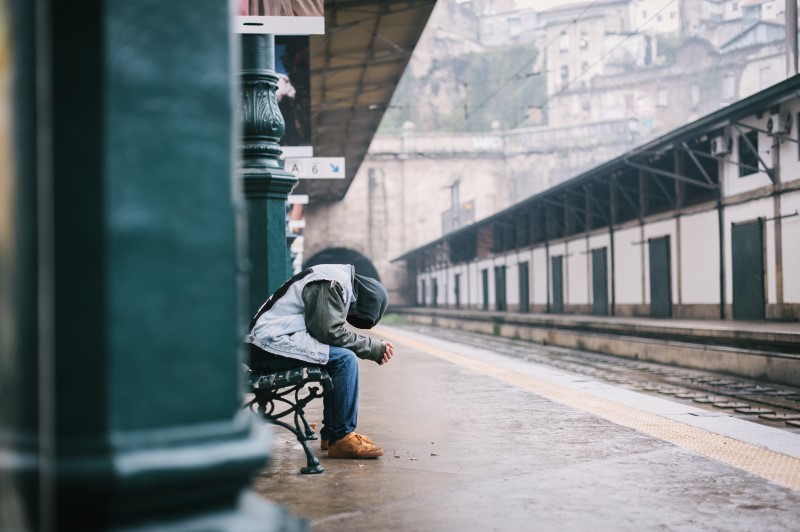 A man alone waiting at the train station