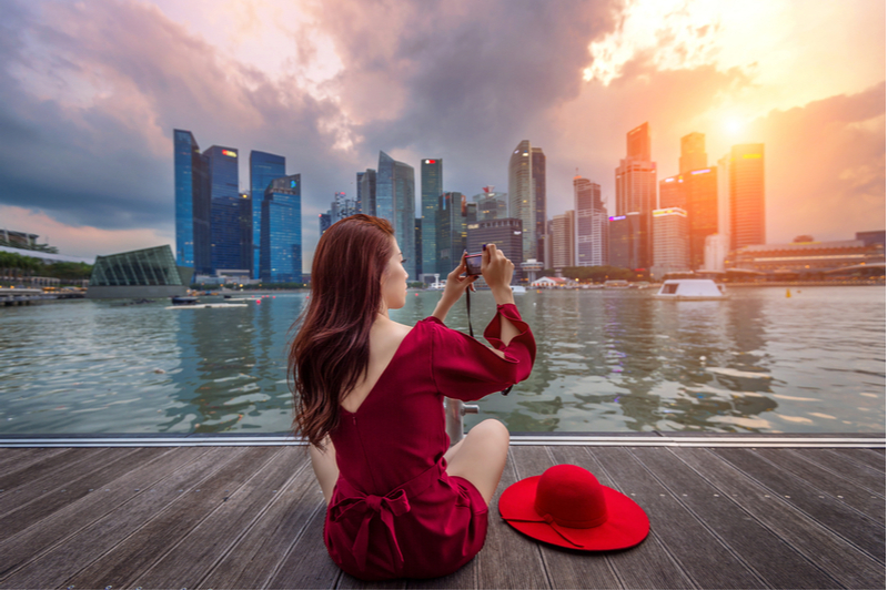 Woman taking photo of Singapore Skyline