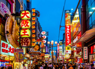 Night shopping street with twilight sky at Dotonbori, famous destination for tourists in Shinsaibashi, Osaka City.