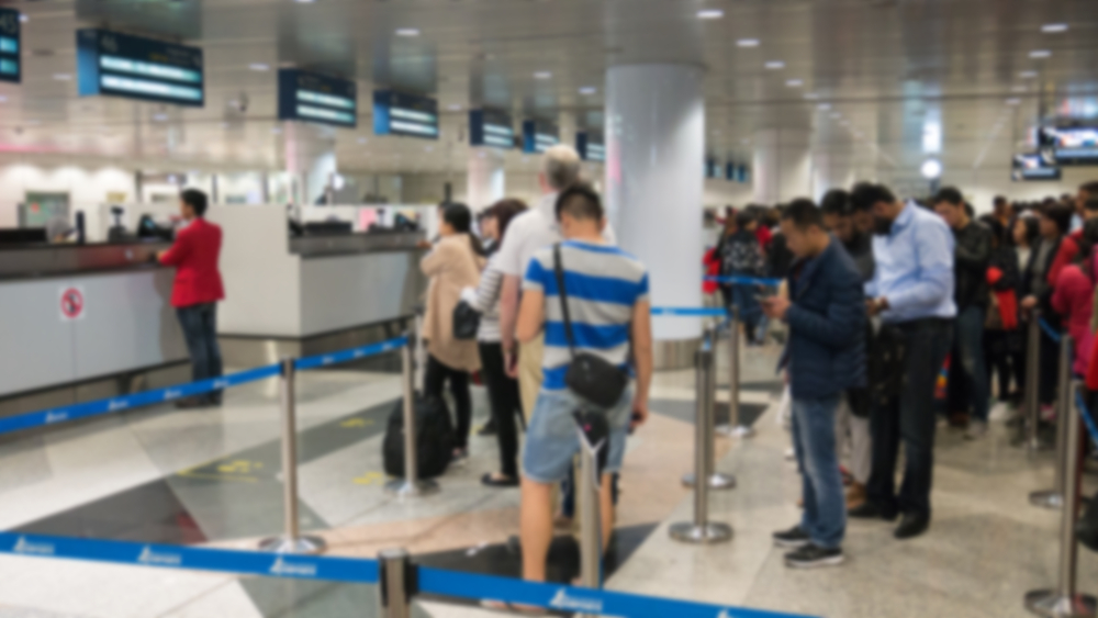 Blurred,Defocused,Image,Of,Group,Travellers,Queue,At,Immigration,Control