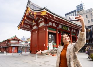 Happy,Asian,Woman,Using,Mobile,Phone,Taking,Selfie,During,Travel