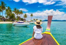 Happy,Traveler,Woman,Relaxing,On,Boat,Near,Tropical,Island,In