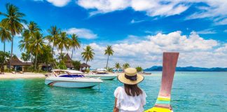 Happy,Traveler,Woman,Relaxing,On,Boat,Near,Tropical,Island,In