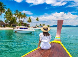 Happy,Traveler,Woman,Relaxing,On,Boat,Near,Tropical,Island,In