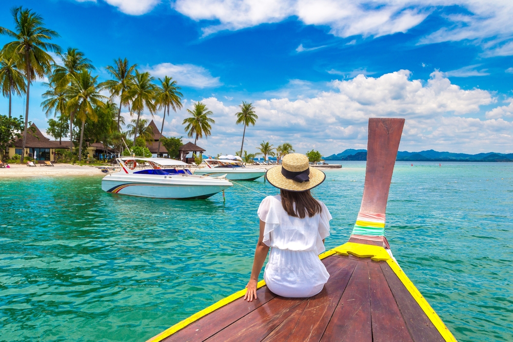 Happy,Traveler,Woman,Relaxing,On,Boat,Near,Tropical,Island,In